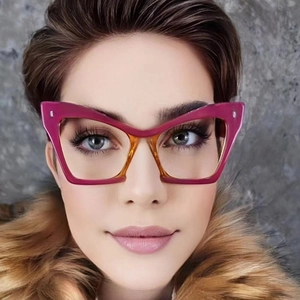 Cat-eye glasses with bold magenta and amber frames featuring metallic rivets