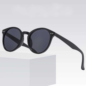 Classic round frame sunglasses in black with silver stud accents and dark lenses