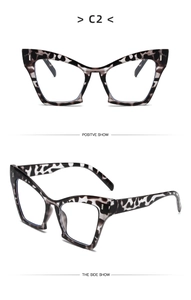 Detail view of cat-eye glasses with black and white marble pattern and metal accents