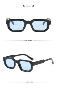 Detail view of rectangular black frame sunglasses with light blue transparent lenses