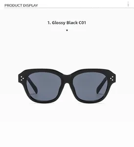 Detail of glossy black square sunglasses frame featuring three silver metal dot accents