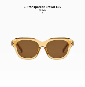 Detail view of transparent brown retro sunglasses with silver metal rivets on the frame