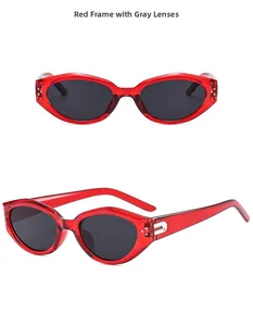 Detail view of retro cat-eye sunglasses featuring transparent red frames and gray lenses