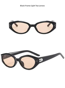 Detail of vintage cat-eye sunglasses with black frames and light tea lenses with silver accents