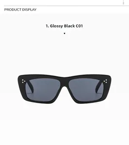 Detail view of square bright black sunglasses with three silver dots and dark grey lenses