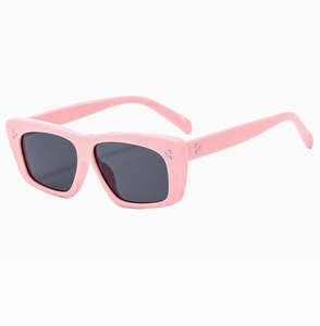 Detail of pink rectangle sunglasses with vintage silver triple dot rivets on the frame