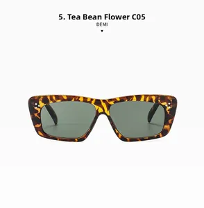 Detailed front view of demi tortoise shell sunglasses with dark green lenses and triple studs