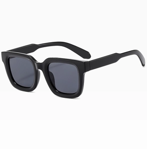 Detail of square oversized sunglasses featuring wide temples and dark grey polarized lenses