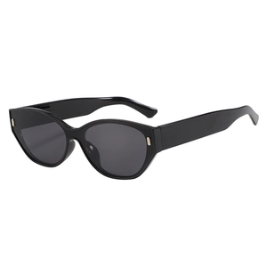 Chic cat eye sunglasses in glossy black frame with dark lenses and gold rivet accents