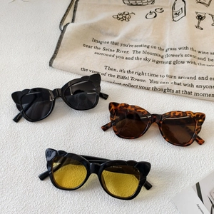 Three pairs of butterfly cat-eye sunglasses in black, tortoiseshell, and yellow tint