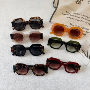 Stylish oversized round geometric sunglasses in multiple colors on white background