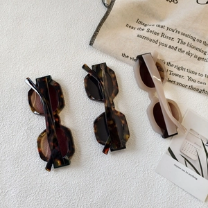Retro oversized round frame sunglasses in tortoise shell and cream on a stylish canvas bag