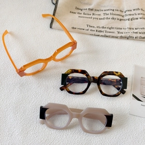Stylish round two-tone sunglasses in orange, tortoiseshell and beige with UV protection