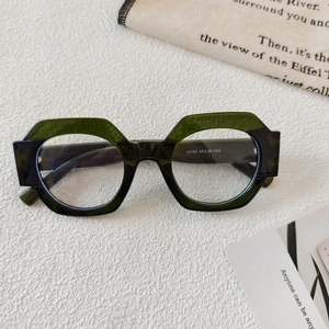Detail view of round color-block sunglasses showing model 13160 on green translucent frame