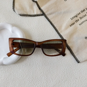 Detailed macro view of retro square sunglasses featuring gradient lenses and frame markings