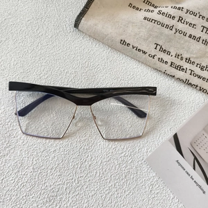 Flat lay of half-rim cat eye anti-blue light glasses on a textured white surface