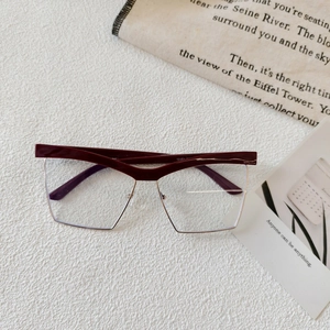 Close-up of semi-rimless geometric wine red and gold fashion glasses frame detail