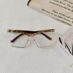 Macro shot of half-frame glasses with marble acetate top and golden metal lower rims