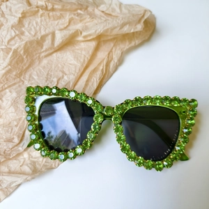 Macro detail of emerald green rhinestones and square frame on party sunglasses