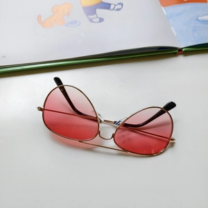 Detail of pink gradient lenses and golden metal frame on kids aviator sunglasses