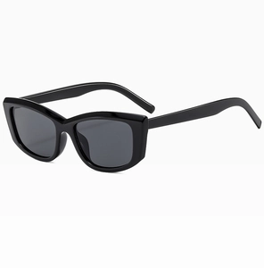 Side view of black cat-eye sunglasses with thick glossy frames and dark lenses