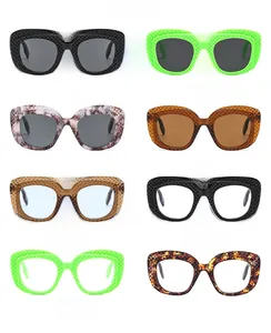 Matrix display of multi-color oval sunglasses with quilted textured frames and UV protection