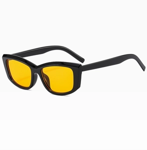 Detail of vintage cat-eye sunglasses with glossy black frames and yellow lenses