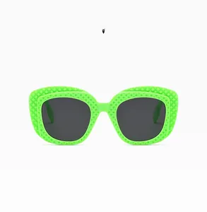 Detail of neon green sunglasses frame with quilted texture and dark grey lenses