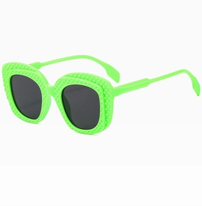 Detailed view of neon green oval sunglasses with unique quilted texture on the frame