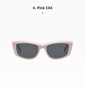 Detailed close-up of rectangular pink cat-eye sunglasses with dark grey tinted lenses