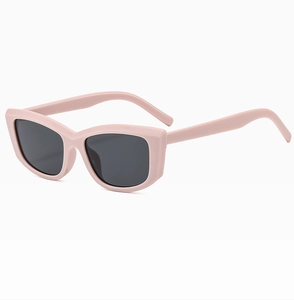 Detailed side view of cream pink cat-eye sunglasses with dark grey UV protective lenses