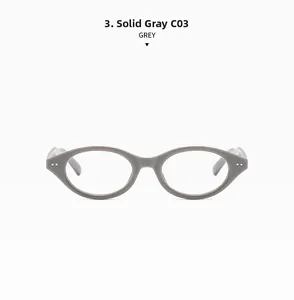 Detail view of oval dark grey eyewear frame with silver rivet accents and smooth finish