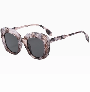 Close-up of marble texture sunglasses frame with quilted diamond relief details