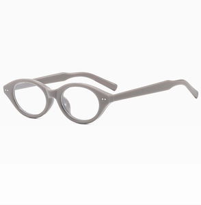 Detail view of oval taupe eyewear frames with premium glossy finish and wide temples