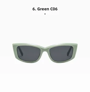 Detail view of mint green rectangle cat-eye sunglasses with dark tinted lenses and C06 code