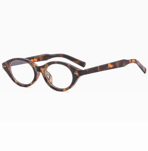 Macro detail of tortoiseshell oval frame glasses with retro metal rivets on temples