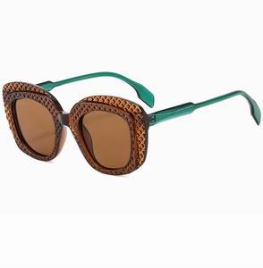 Close-up of brown textured sunglasses frames with translucent green temples detail