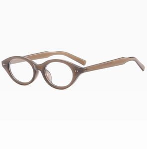 Detail view of oval cat-eye glasses with brown translucent frames and silver rivets