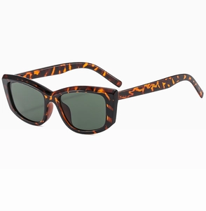 Detail shot of vintage cat-eye sunglasses with tortoiseshell frames and dark green lenses