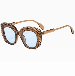 Detail of oval sunglasses with brown lattice frame and light blue tinted lenses
