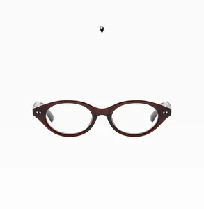 Detail of oval vintage brown glasses frames with metal rivets and transparent finish
