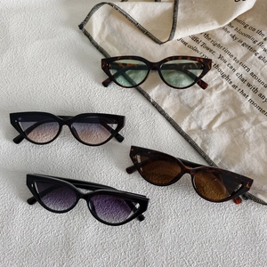 Retro cat eye sunglasses set in tortoise shell and black frames with gradient lenses