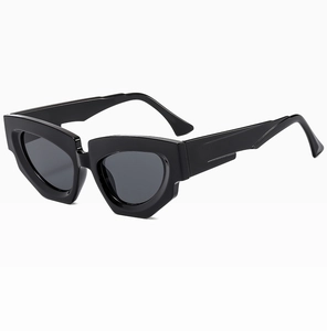 Macro view of black irregular cat eye sunglasses with thick geometric frames