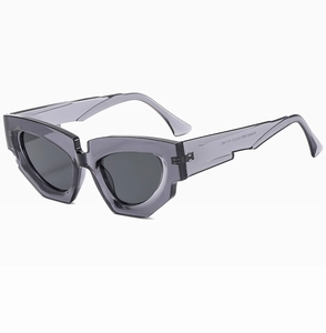 Detail view of cat eye sunglasses showing geometric grey frame and UV protective lenses