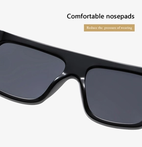 Detail of comfortable integrated nose pads on glossy black oversized sunglasses