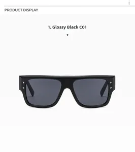 Close-up of glossy black square sunglasses with silver metal dots and dark grey lenses