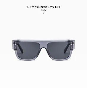 Detail of transparent grey square sunglasses with stylish metal rivets and dark lenses