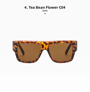 Detail of square tortoiseshell sunglasses with brown lenses and metal rivet accents