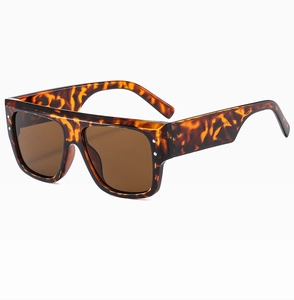 Detail of square flat top leopard print sunglasses with brown lenses and silver rivets