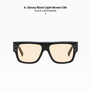 Detail shot of black rectangular frame sunglasses with light brown lenses and silver rivets
